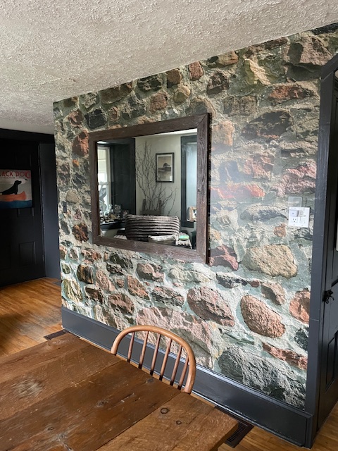 Field Stone Wallpaper, as seen on the wall of this dining room, is a wall mural with realistic stones from About Murals