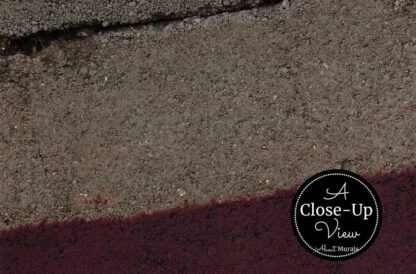 A close-up of a purple painted stripe on a grey wall in this Grey and Purple Concrete Wallpaper from About Murals.