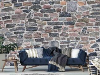 Old Stone Wallpaper, as seen on the wall of this living room, is a photo mural of a real multicolored old stone wall from About Murals.