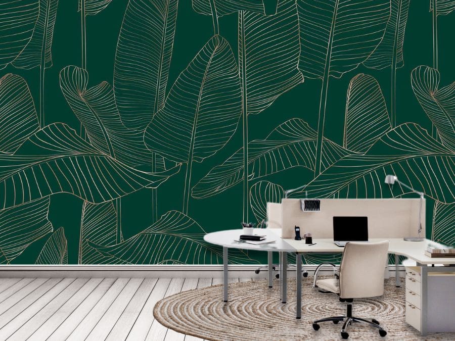 Banana Leaf Wallpaper, as seen on the wall of this office, is a tropical mural with gold leaves outlined on a dark green background from About Murals.