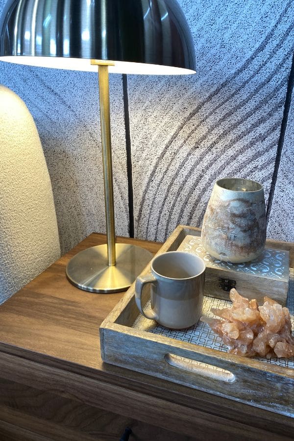 Scandi Leaf Wallpaper, as seen on Cityline's zen interior design episode by Colin & Justin, is a wall mural of a natural leaf pattern raked into gray sand from About Murals.