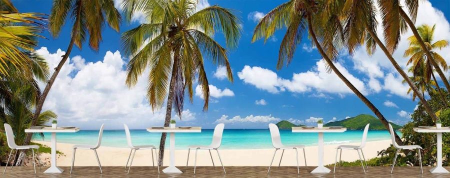 Beautiful Beach Wallpaper, as seen on the wall of this tropical themed restaurant, is an extra large photo mural of palm trees, a sandy beach, sea and tropical islands from About Murals.