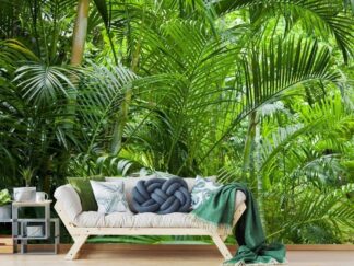 Green Rainforest Wallpaper, as seen on the wall of this living room, is a photo mural of palm trees with lots of palm leaves in a tropical jungle from About Murals.