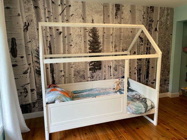 Aspen Wallpaper, as seen on the wall of this bedroom, is a high resolution photo wall mural of gray Aspen trees in a forest in Elk Mountains, Colorado from About Murals.
