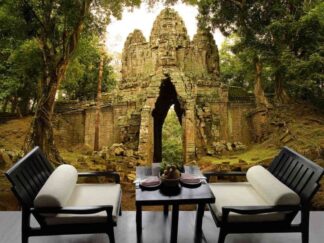 Angkor Thom Wallpaper, as seen on the wall of this living room, is a photo mural of an entrance gate leading to Bayon Temple in Cambodia, from About Murals.