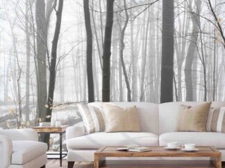 Winter Forest Wallpaper, as seen on the wall of this living room, is a photo mural of snow thawing around foggy trees from About Murals.