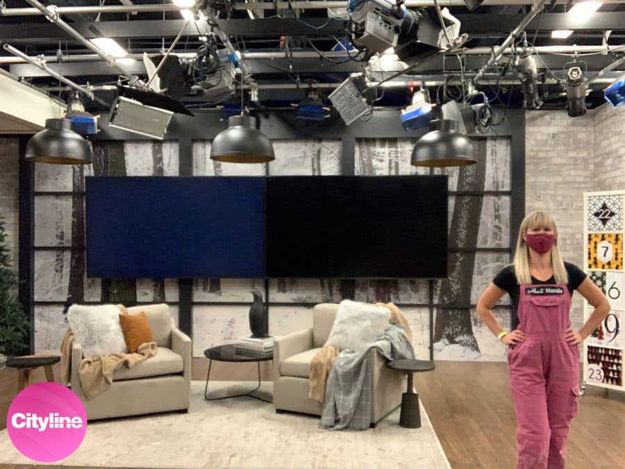 Winter Path Wallpaper, as seen on the wall of this Christmas set on Cityline, is a photo wall mural of a forest path on a snowy day from About Murals.