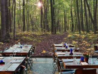 Beautiful Forest Wallpaper, as seen on the wall of this restaurant, is a high resolution photo mural of a sun shining through trees onto a leafy path from About Murals.