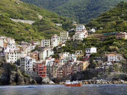 Cinque Terre Wallpaper is a photo wall mural of buildings in a mountainside village overlooking the sea in Italy from About Murals.