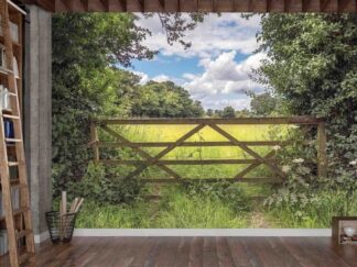 Country Fence Wallpaper, as seen on the wall of this library, is a photo mural of a wooden fence near a farm from About Murals.