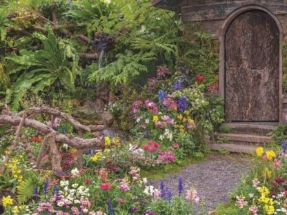 English Garden Wallpaper is a photo mural of colourful summer flowers lining a path to a cottage door from About Murals.