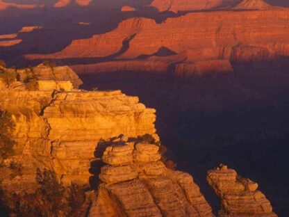 Grand Canyon Wallpaper is a photo wall mural of the sun rising over orange rock from About Murals.