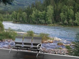 Flowing River Wallpaper, as seen on the wall of this waiting room, is a photo mural of water streaming over rocks surrounded by pine trees in a forest from About Murals.