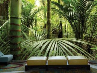 Rainforest Wallpaper, as seen on the wall of this living room, is a photo mural of palm trees and bamboo tree in a tropical jungle from About Murals.