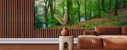 Ireland Forest Wallpaper, as seen on the wall of this living room, is a photo mural of beautiful green trees in a forest overlooking a peaceful river from About Murals.