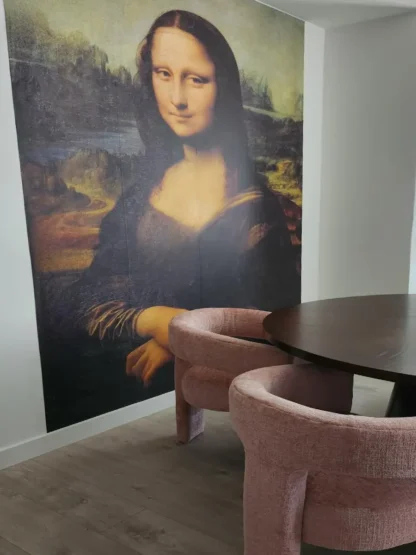 Mona Lisa Wallpaper, as seen on the wall of a dining room, is a wall mural that adds a sophisticated feeling with a replica of the famous painting by About Murals