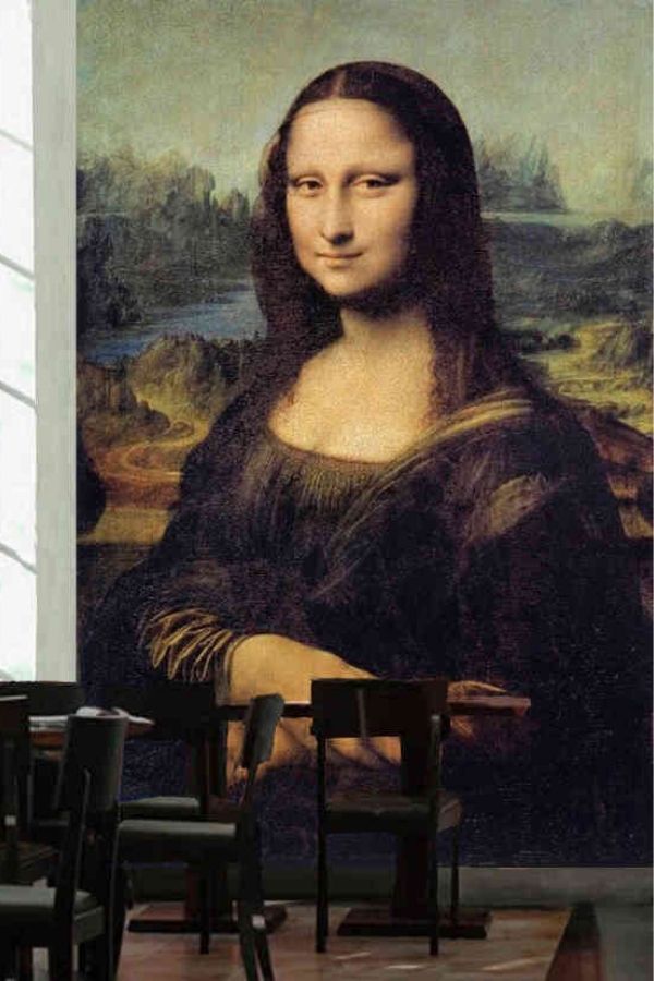 Mona Lisa Wallpaper, as seen on the wall of this restaurant, is a mural of the painting by Leonardo da Vinci of a woman’s face with large eyes and a slight smile from About Murals.