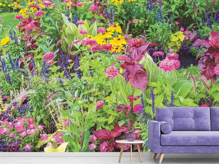 Summer Flower Wallpaper, as seen on the wall of this living room, is a photo mural of colorful flowers in a garden from About Murals.