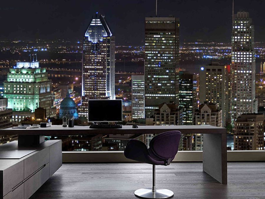 Montreal at Night Wallpaper, as seen on the wall of this urban office, is a photo mural of city lights and towers under a black evening sky in Canada.  Dark Cityscape Wallpaper sold by About Murals.