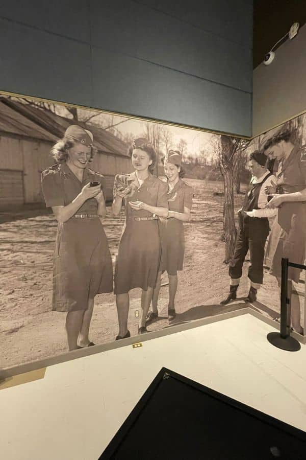 Museum Wallpaper, as seen on the wall of the St. Catharines Museum, is a vintage photo mural of women during World War 2 from About Murals.