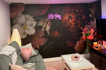 Dutch Floral Wallpaper, as seen on the wall of this modern living room, is a floral wallpaper with moody orange peonies on a black background from About Murals Canada