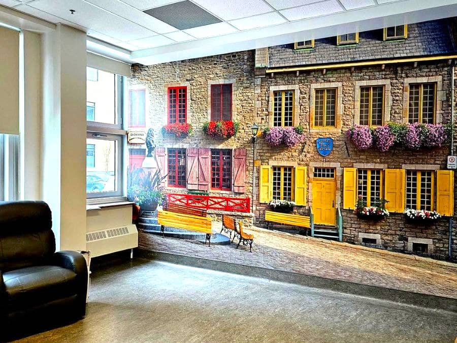 Care Home Wall Murals, like this one of a historic building in Place Royale, Quebec with colourful windows, can make residents feel at home.