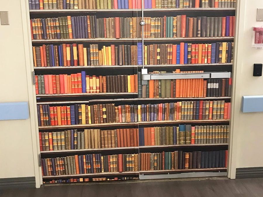 Dementia unit door murals disguises doors with images like this bookshelf, to discourage memory care patients from exiting the facility.