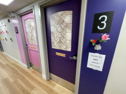 Dementia Door Wrap, as seen on two bedroom doors of a Toronto care home, is a durable wallpaper that looks like a real front door to help residents find their room more easily – from About Murals Canada.
