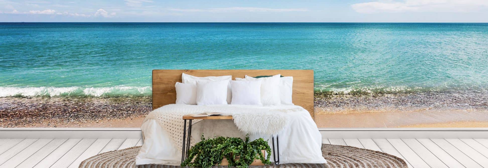 Beach wallpaper, as seen on the wall of this bedroom, is an ocean wall mural created from a photo of turquoise water lapping onto a sandy tropical beach from About Murals.
