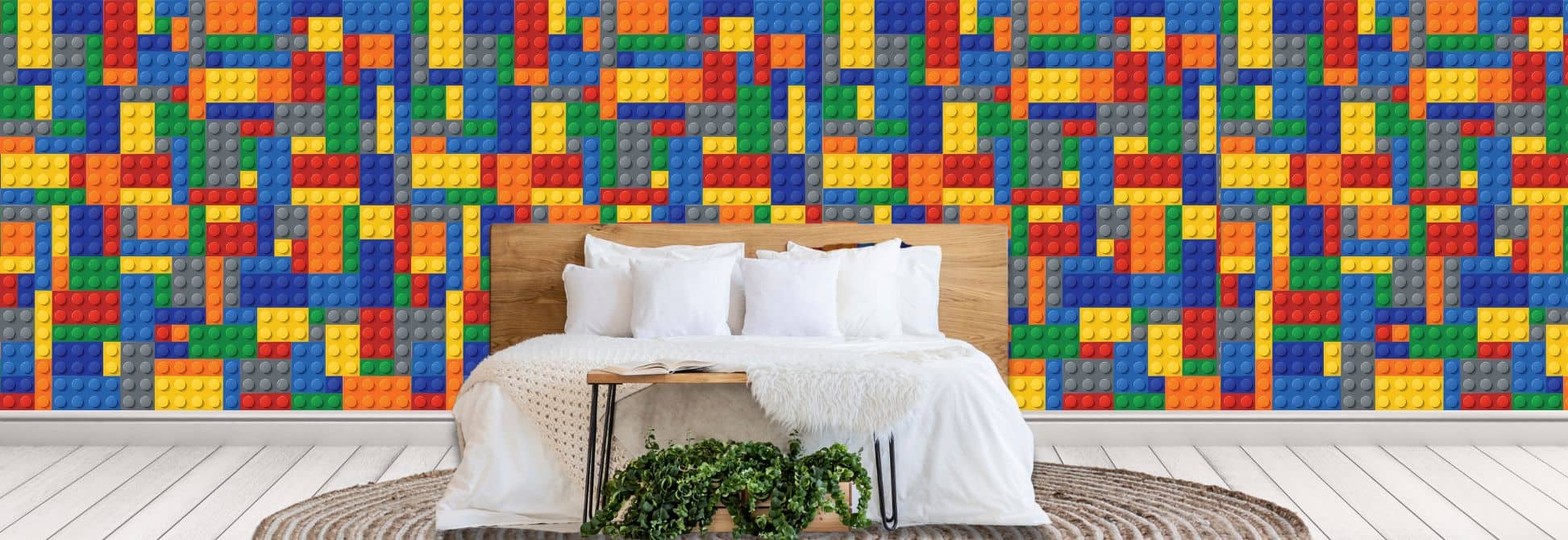 Children’s graphic wallpaper, as seen on the wall of a kids bedrooms, is a wall mural with a colourful lego block design from About Murals.