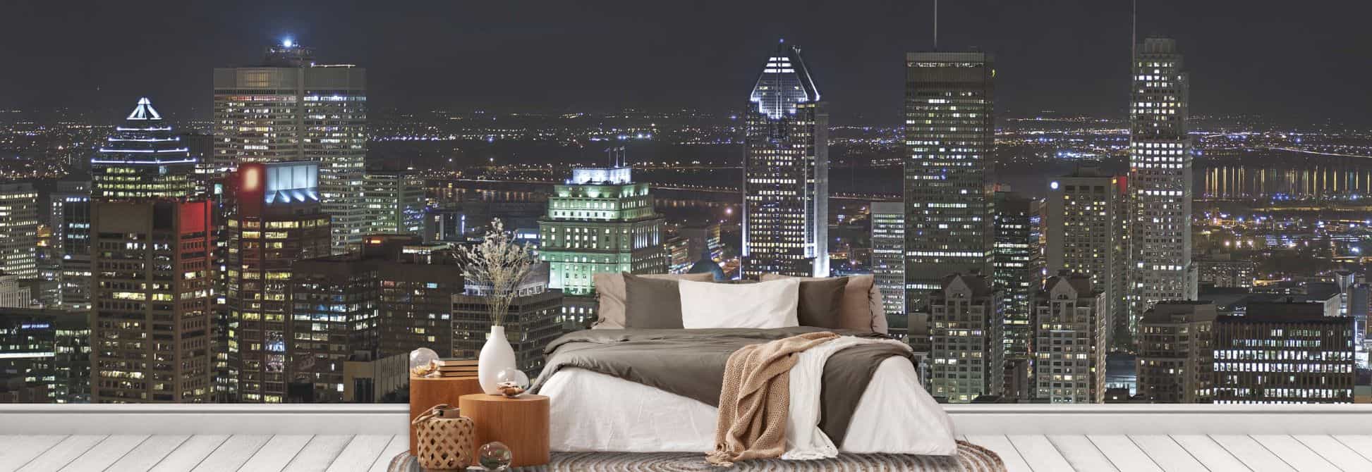 City skyline wallpaper, as seen on the wall of this bedroom, is a cityscape wall mural created from a high resolution photo of downtown Montreal at night with lit up buildings from About Murals.