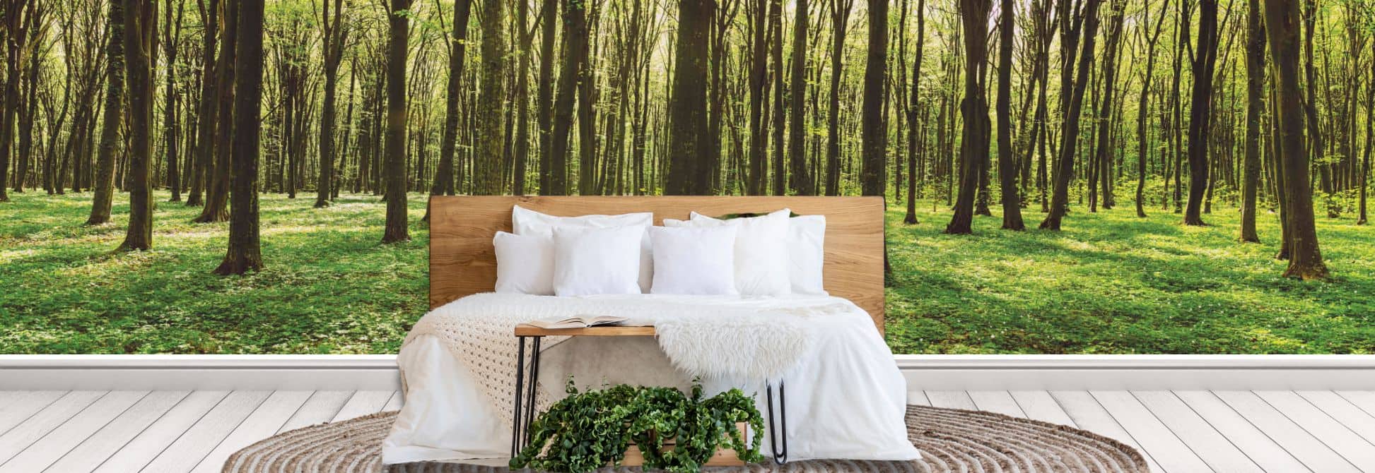 Forest wallpaper, as seen on the wall of a bedroom, is a wall mural featuring lush green trees and immersive woodland scenery from About Murals.