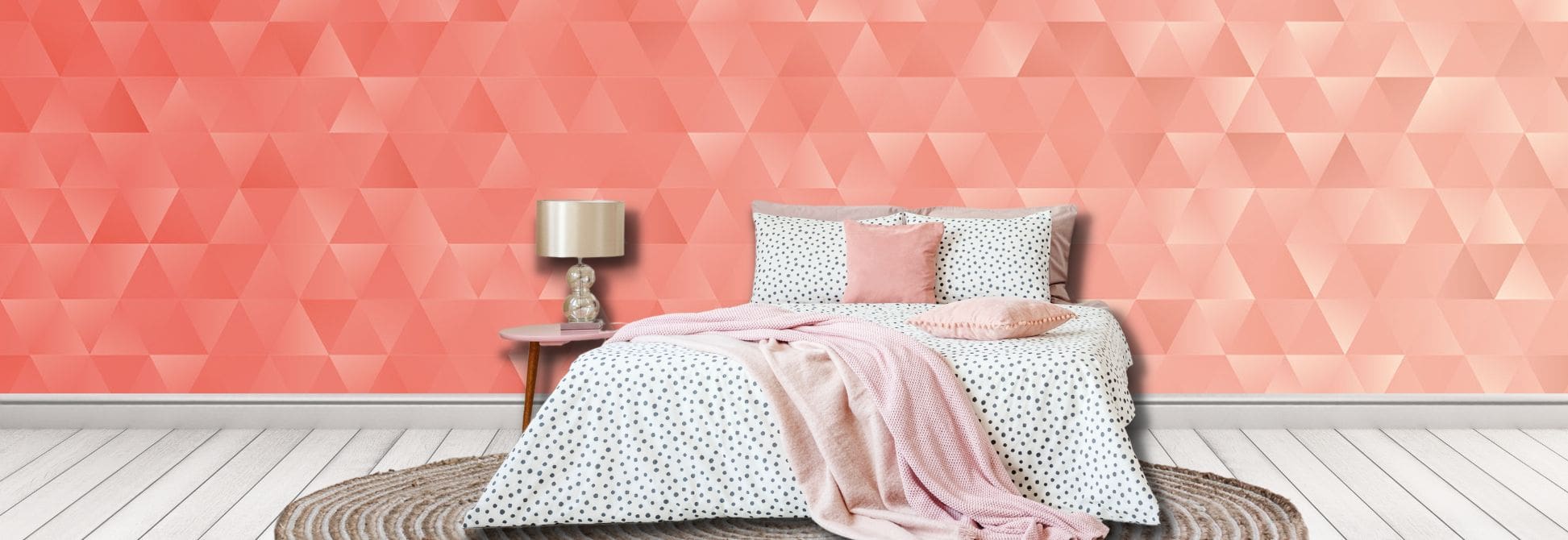 Geometric wallpaper, as seen on the wall of this bedroom, is a wall mural with coral coloured 3D triangles from About Murals.