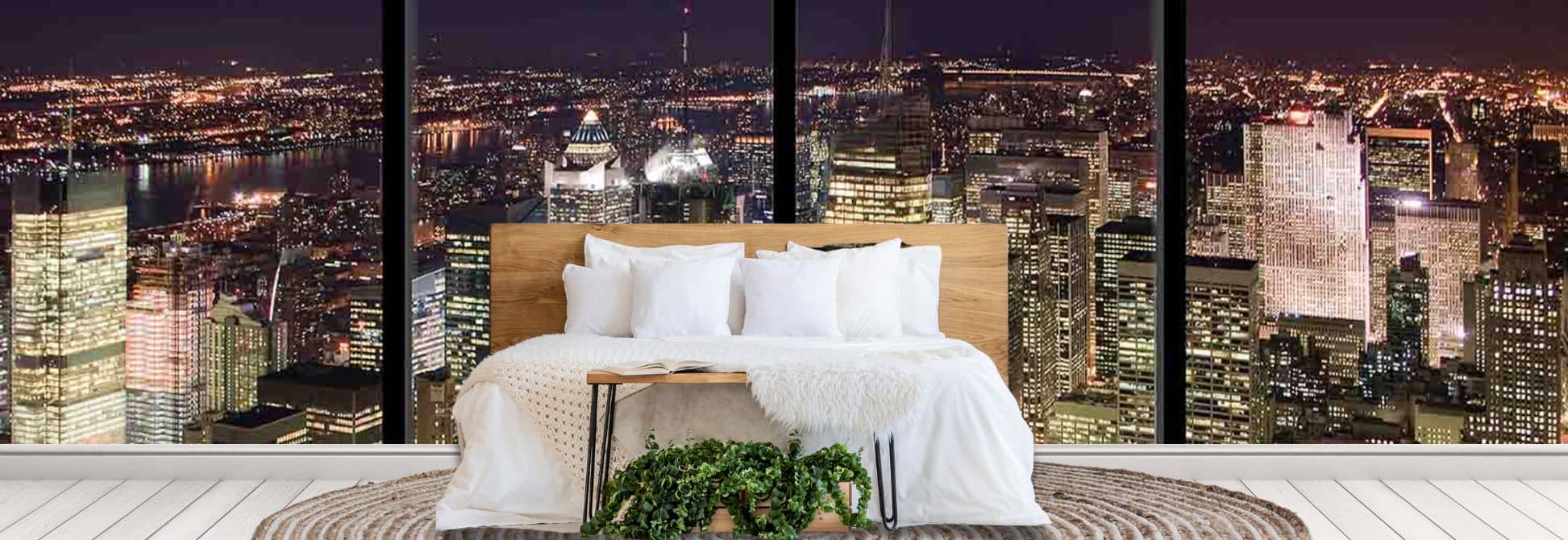 USA City Wallpaper Mural, as seen on the wall of this bedroom, is a photo wall mural of an American skyline filled with high rise buildings all lit up against a dark night sky from About Murals
