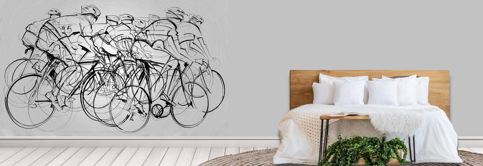 Bike murals, as seen on the wall of this bedroom, is a bike wallpaper featuring illustrated riders cycling on road bikes on a grey background from About Murals.