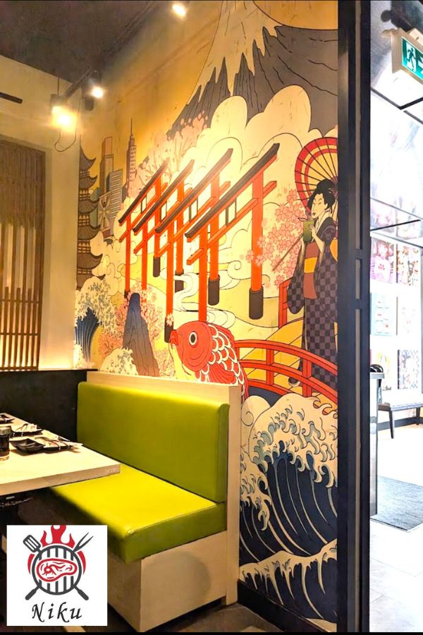 Restaurant mural wallpaper, seen behind a booth, at Niku Japanese restaurant in Niagara Falls by About Murals.