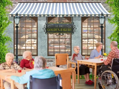 Bakery Shop Wallpaper, as seen on the wall of this memory care dining room, is a mural featuring the exterior of a vintage pastry shop with a grey awning, 2 black lamp posts and surrounded by flowers from About Murals