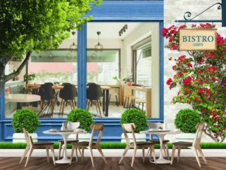 Blue Bistro Wallpaper, as seen on the wall of a restaurant, is a mural featuring an exterior view of a cafe window surrounded by plants and flowers, looking inside the bistro with tables and chairs from About Murals Canada.
