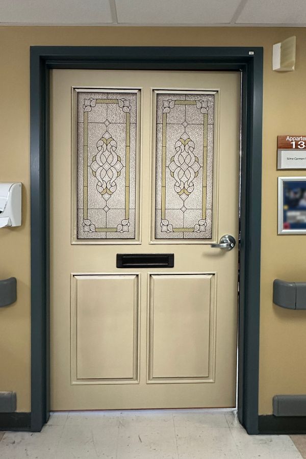 Dementia Door Wallpaper, as seen in this care home hallway, is a door wrap to help Alzheimer residents find their bedroom easier from About Murals