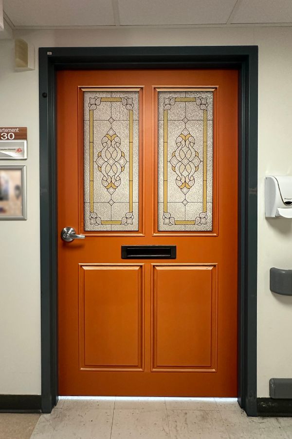 Dementia Door Wallpaper, as seen on a resident bedroom door, is an orange door decal from About Murals