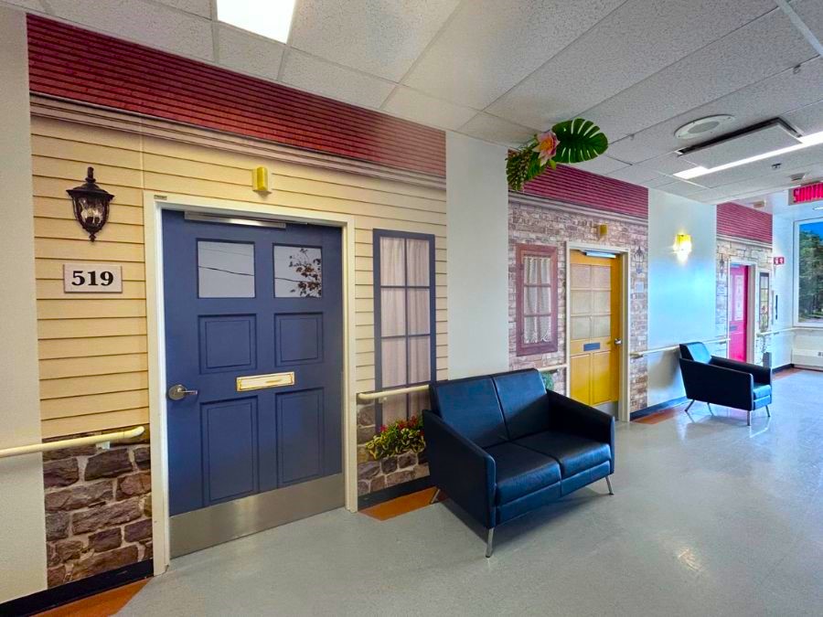 Dementia friendly door wraps on bedroom doors of a memory care facility from About Murals