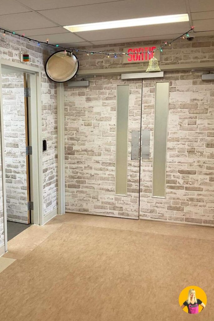 Door murals for dementia units, in a grey brick design, covering all walls, two double exit doors and one single door, in order to reduce exit-seeking behaviour in residents of a memory care center from About Murals.