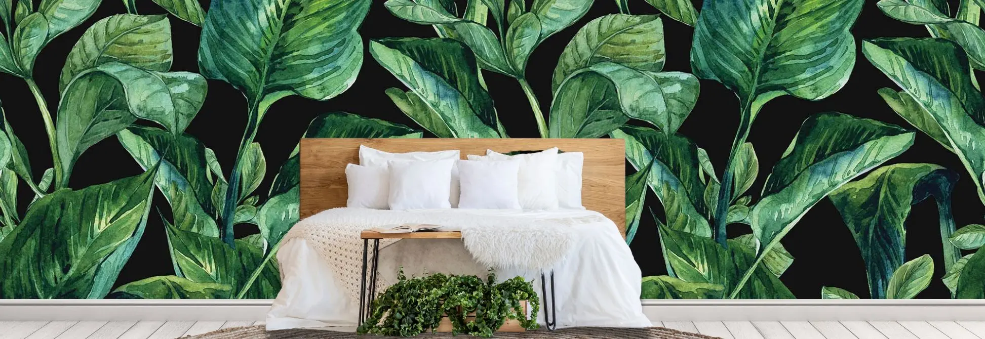 Tropical wallpaper, as seen on the wall of this bedroom, is a jungle leaf wall mural featuring green banana leaves on a dark background from About Murals.
